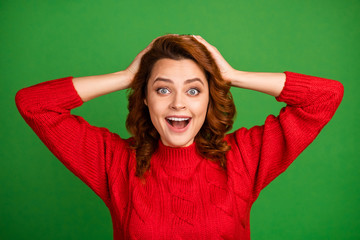 Portrait of astonished positive woman hear wonderful lottery win novelty impressed touch hands redhead scream wear knitted winter sweater isolated over vivid color background