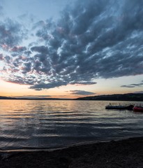 Fototapeta na wymiar Sunset on lake sempach majestic atmosphere rubber boats