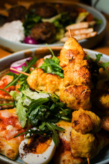 Chicken tandoori with rucola salad, egg with sumac spice, pitta bread. Asian dish