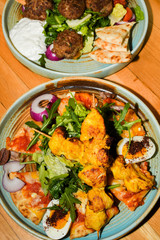 Chicken tandoori with rucola salad, egg with sumac spice, pitta bread. Asian dish