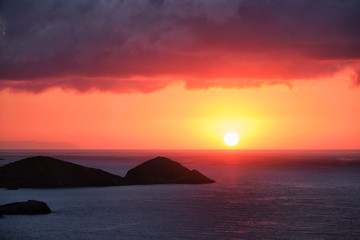 Fototapeta na wymiar Sea sunset. Seascape sunset with island. Sun setting down in sea. Crete island, Greece