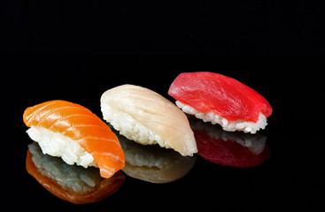 Simple sushi nigiri maki set isolated on black background. Various selection of traditional japanese food. © Alexe