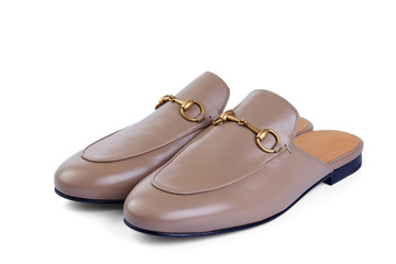 Men's lightweight home shoes in thin beige leather with elegant metal buckle without backrests insulated on white background with shadow. Top view at an angle.