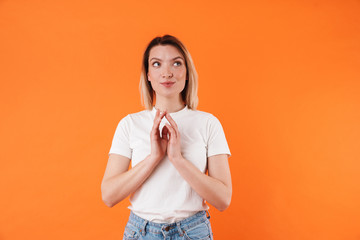 Image of pleased attractive woman dreaming and looking upward