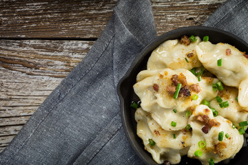 Fried dumplings (pierogi) with meat filling sprinkled with greaves.