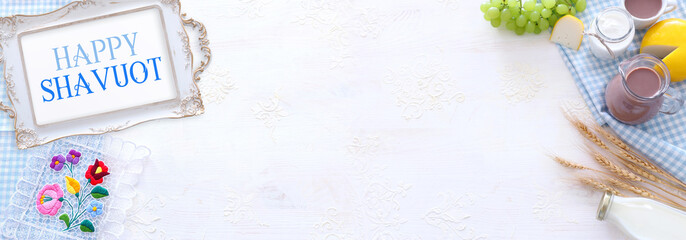 Top view photo of dairy products over white background. Symbols of jewish holiday - Shavuot