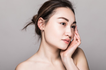 Close up young beautiful woman face isolated on gray background
