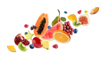 Set of different cut fresh fruits and berries on white background