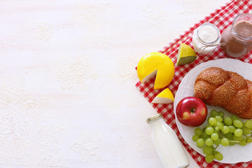 Top view photo of dairy products over white background. Symbols of jewish holiday - Shavuot