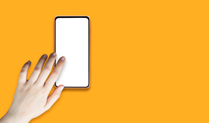 The woman's hand and smartphone on an orange background.