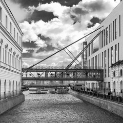 black and white photo of the suspension bridge over the canal between the buildings of the Mariinsky Theater in St. Petersburg, Russia