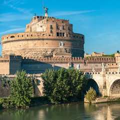 Fototapeta premium castle of the Holy Angel and a bridge with beautiful sculptures of angels on a background of blue sky