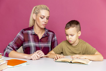 Fototapeta premium Distance education. Mother helps pre-school kid to do lessons. Education at quarantine time.