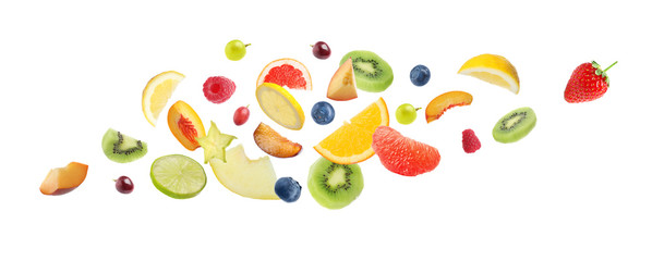 Set of different cut fresh fruits and berries falling on white background. Banner design