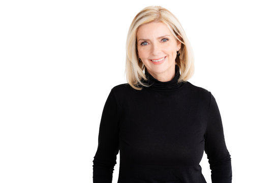 Attractive blond woman looking at camera and smiling while standing at isolated white background