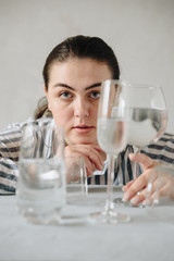 beautiful girl with glasses of water on the table