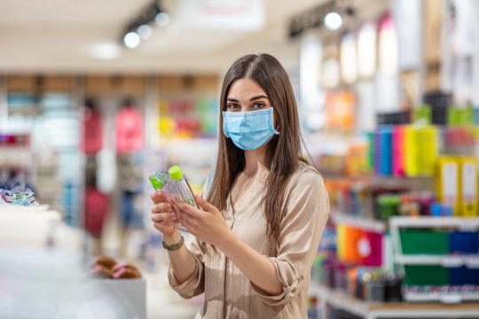 Woman wearing protective mask while buying in grocery store during virus epidemic. Portrait of a girl after the flu virus epidemic, close-up. Woman wearing protective mask while grocery shopping