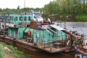 Old abandoned river port on the river cargo rusty ships