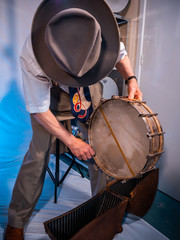 Antique 1920s snare drum being removed from original case by a gentleman in period clothing. 
