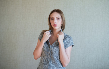 Serious face. A female portrait against an abstract grey background.