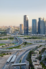 Fototapeta premium View of a road junction with moving cars on the background of a modern city