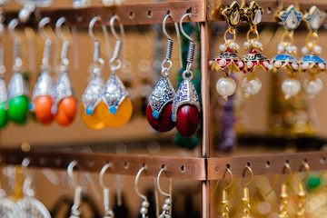 Close up shot of ethnic and designer ear rings in beautiful colors made with stone, pearl and metal.