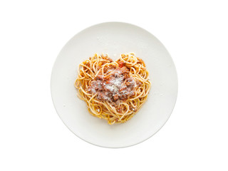 Spaghetti bolognese on a plate isolated on white background.  Selective focus.  Heart shape of spaghetti. 