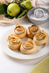 Apple roses puff pastry cakes on white background.