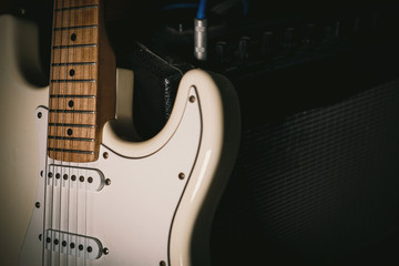 The Guitar and Amplifier Closeup detail in the dark background 