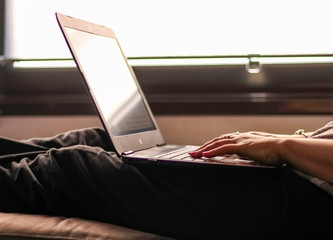 Person typing on laptop in their leisure time