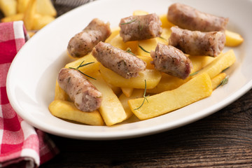 Fried potatoes with italian traditional salsiccia, selective focus