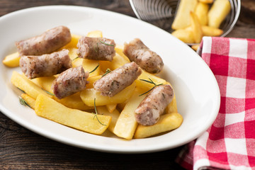 Fried potatoes with italian traditional salsiccia, selective focus