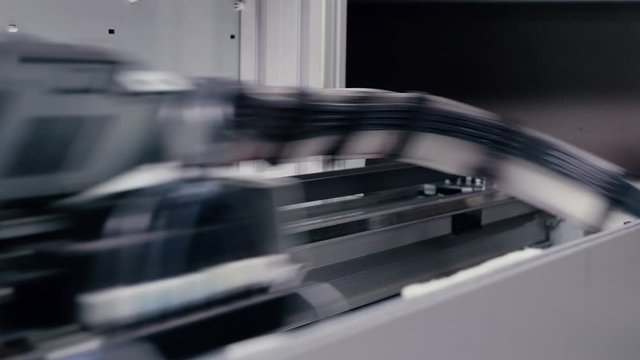 Moving print head of a large printing press.