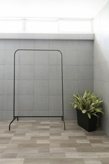 front view of empty black metal clothes drying rack or clothesline with stainless steel rail and...