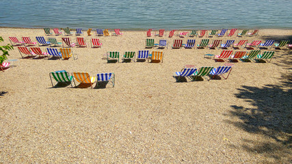 Colorful empty chairs on luxury resort beach hotel.