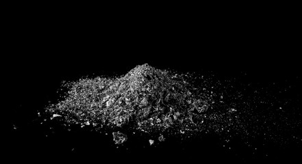 Cigarette ash pile isolated on black background, texture