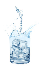 Water splashing out of glass with ice cubes on white background. Refreshing drink