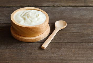 Fototapeta na wymiar Natural flavored yogurt, put on a stew and use a wooden spoon to eat.