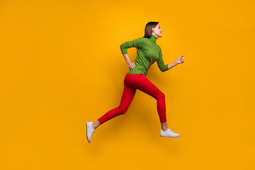 Fototapeta na wymiar Full length photo of cheerful content girl jump run after black friday sales wear casual style clothing isolated over vivid color background
