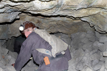 A miner walks through a dangerously unstable shaft of a mine in Cerro Rico.