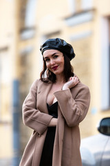 Woman in black pantsuit walks on promenade