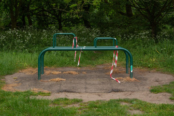 Exercise equipment in park with caution tape during coronavirus pandemic