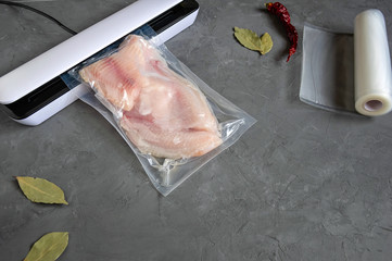 Vacuum fish packaging for long-term storage. The use of a vacuum sealer for long-term storage of products. Top view.