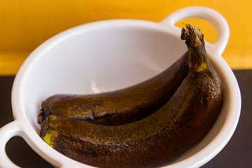 old dark over ripe banana pair with water droplets over it