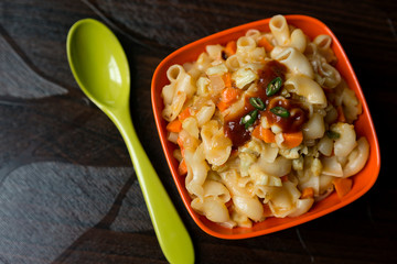 Indian style of pasta with veggies and sauce on table top