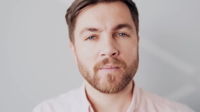 handsome artistic man tones his face with a sponge