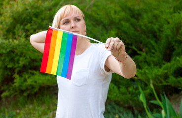 Girl with LGBT flag in hands, concept of gender equality. Lesbian and gay discrimination support LGBT pride