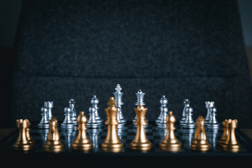 Front view of chess game on chessboard with blur foreground. Business game competitive strategy....