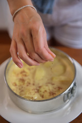 A beautiful woman bakes a homemade apple cake in her home kitchen
