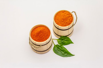 Two types of Hungarian paprika powder, hot and sweet, isolated on white background